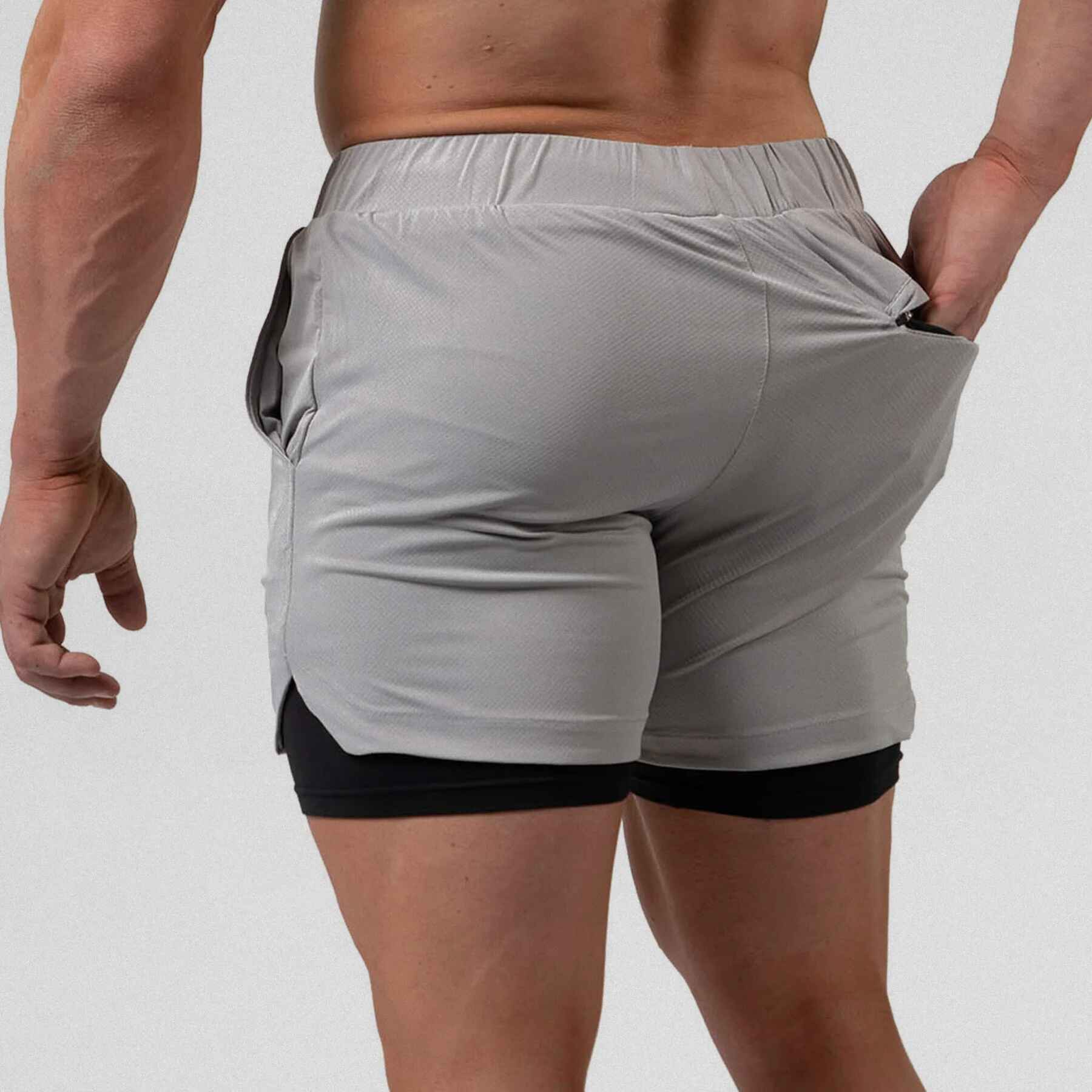 Gymreapers react training shorts slate with athlete wearing them, zoomed in to back showing pocket.