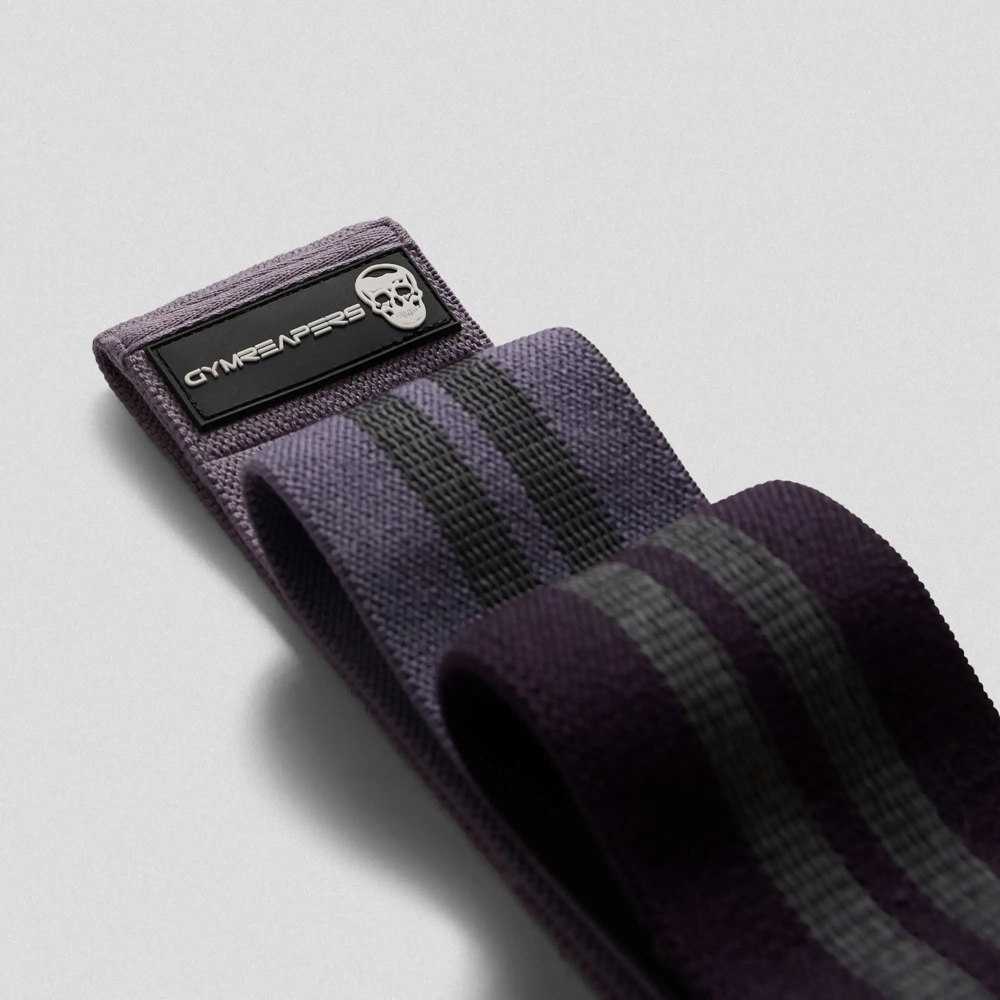 photo of purple hip bands stacked on gray background 